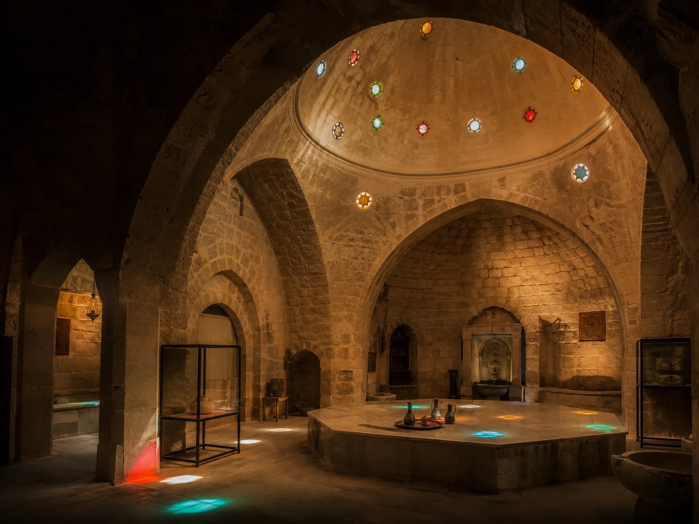 Vaulted Ottoman bathhouse interior with stone arches and skylight